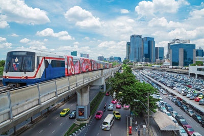 Cars on road in city against sky