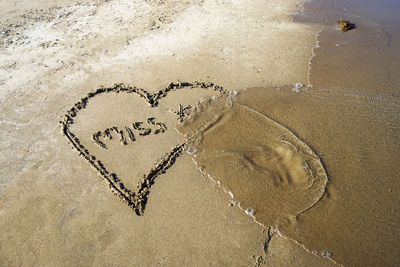 Close-up of heart shape on sand