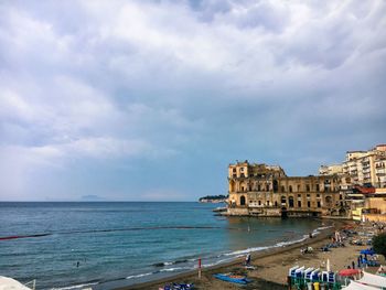 Scenic view of sea against sky in city