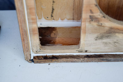 High angle view of ice cream in container on wooden building