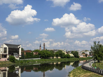 Scenic view of lake by buildings against sky