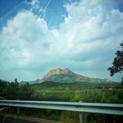 Scenic view of mountains against cloudy sky