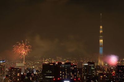 Firework display over city at night