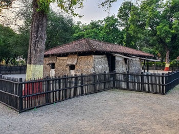 House by trees against building