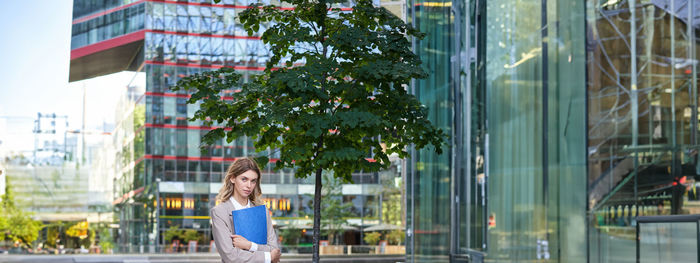 Rear view of woman standing in city