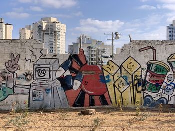 Graffiti on wall against buildings in city