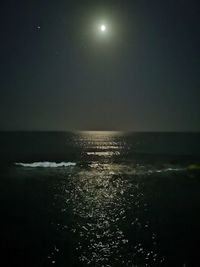 Scenic view of sea against sky at night