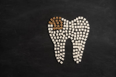 Low section of people standing against black background