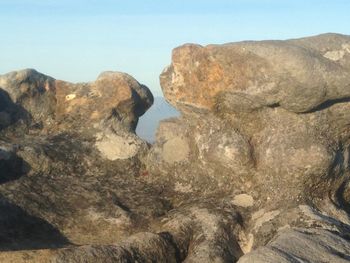 Rocks on mountain against clear sky