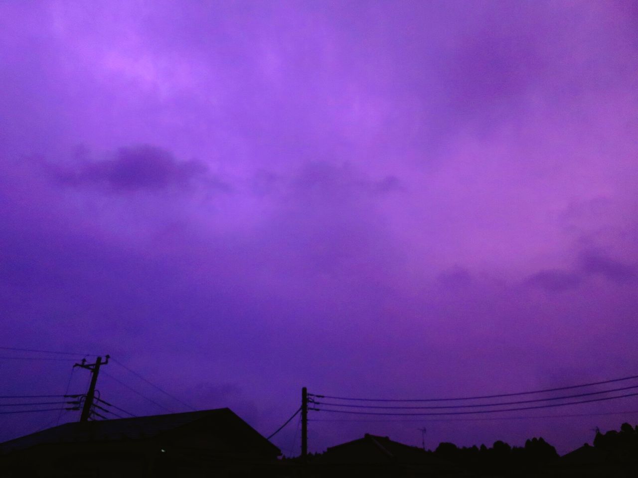 LOW ANGLE VIEW OF SILHOUETTE ELECTRICITY PYLON AGAINST PURPLE SKY