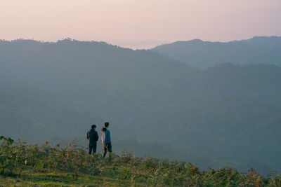 Group of hiker man relax with wellbeing and happy feeling on top of mountain