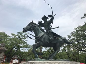 Low angle view of statue against sky