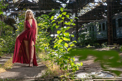 Woman standing by plants