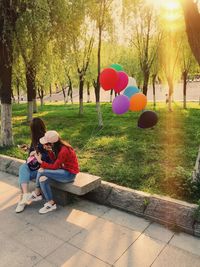 Rear view of women sitting at park