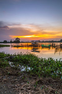Scenic view of lake against sky during sunset