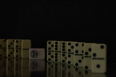 Close-up of piano keys against black background