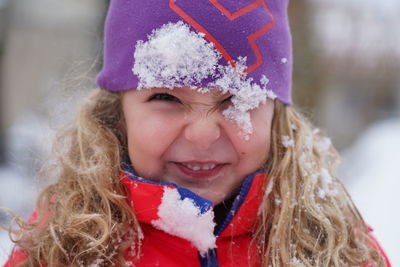 Portrait of cute smiling girl in snow