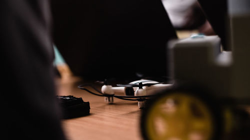 Close-up of man playing guitar on table