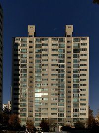 Low angle view of buildings against blue sky