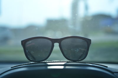 Close-up of sunglasses on car