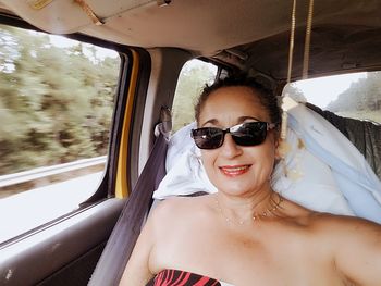 Portrait of smiling woman in car