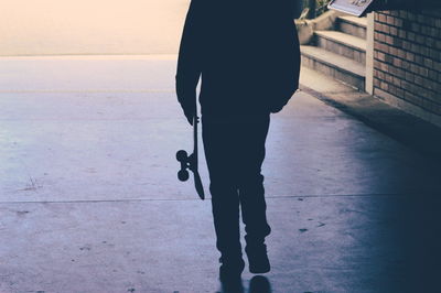 Low section of man standing on street