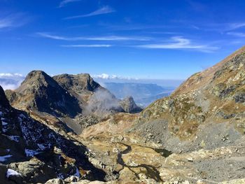 Scenic view of mountains against blue sky