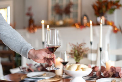 Cropped hand of woman preparing food on table