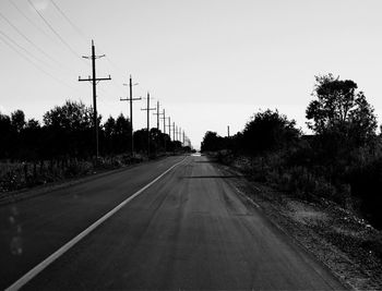 Empty road along trees