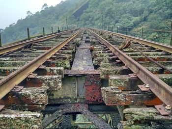 Abandoned railroad tracks by mountain