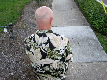 Rear view of man sitting on road