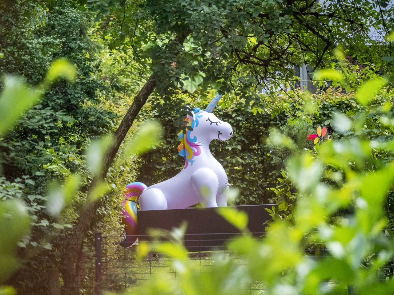 green, plant, tree, flower, nature, representation, grass, day, sunlight, growth, forest, garden, animal representation, jungle, park, focus on background, outdoors, selective focus, leaf, cartoon, autumn, human representation, one person, creativity