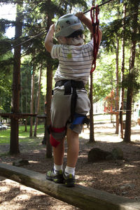 Full length of man standing by tree in forest