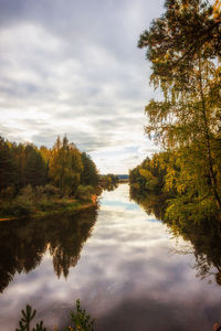 Reflection of trees in lake against sky