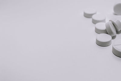 Close-up of stack of table against white background
