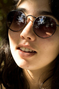 Portrait of woman in sunglasses outdoors