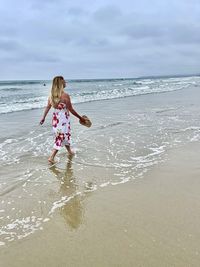 Lady walking alone on beach 