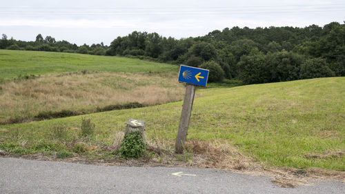 Road sign against sky