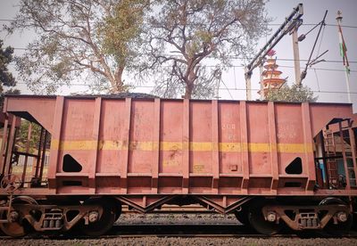 Train by railroad tracks against sky