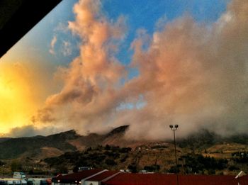 Scenic view of mountains against cloudy sky