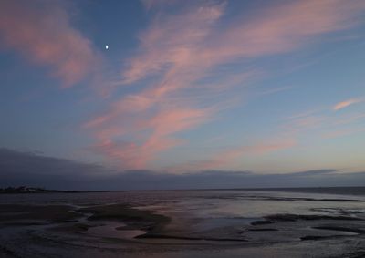 Scenic view of beach against sky during sunset