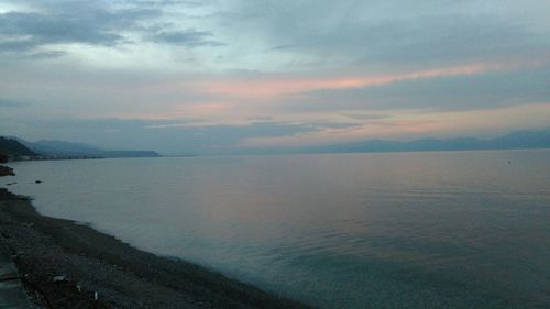 Scenic view of sea against cloudy sky