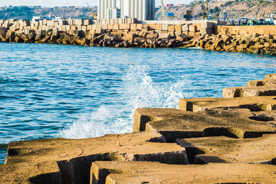 Scenic view of sea by city against sky