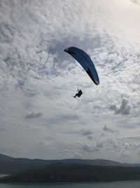 Person paragliding against sky