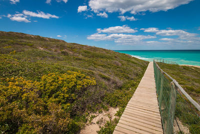 Wooden footpath walkway leading to indian ocean beach at de hoop nature reserve, south africa
