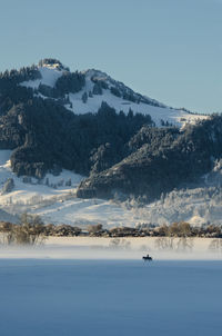 Scenic view of snow covered mountain against sky