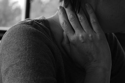 Close-up of woman touching neck in pain