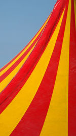 Low angle view of multi colored flag against clear sky