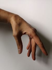 Close-up of hands over white background