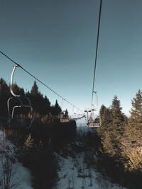 Overhead cable car against sky during winter